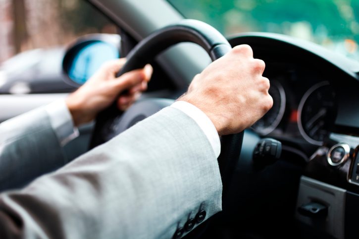 image of man holding steering wheel