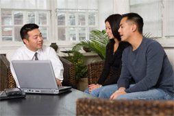 image of couple talking with insurance agent